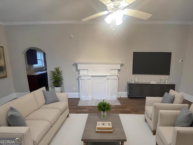 living room with crown molding, ceiling fan, and dark hardwood / wood-style flooring