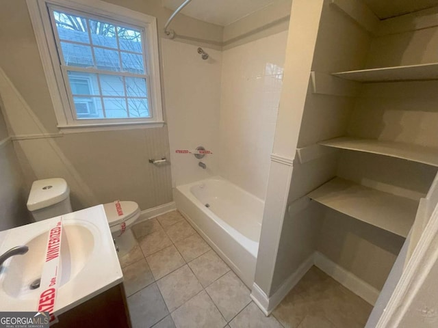 full bathroom featuring tiled shower / bath, vanity, toilet, and tile patterned flooring