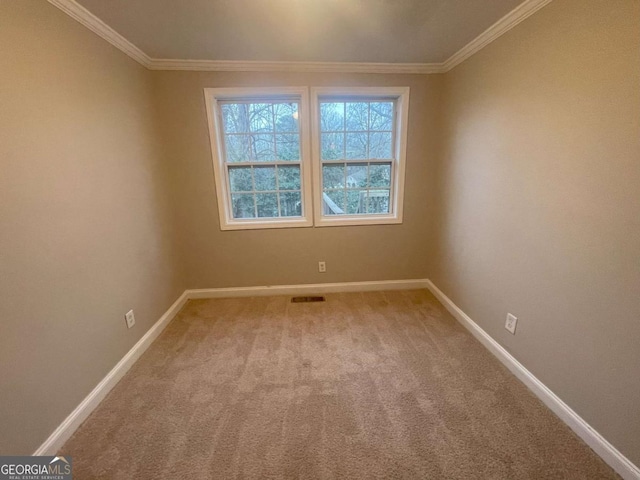 carpeted spare room with crown molding