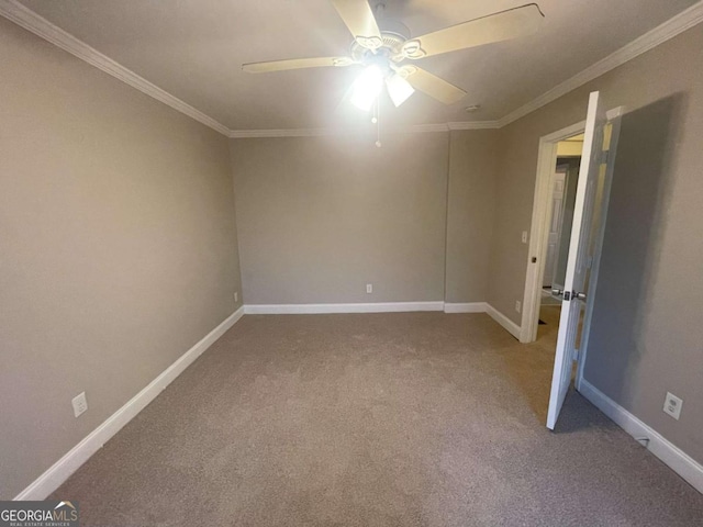 spare room with crown molding, carpet, and ceiling fan