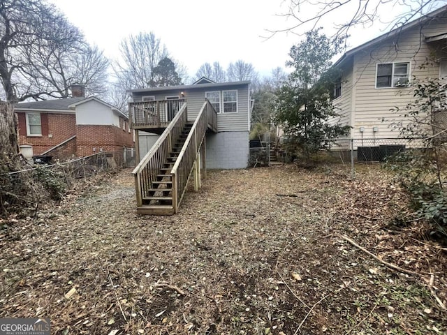 back of property featuring a wooden deck