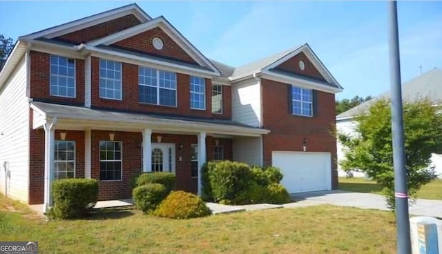 view of front of home with a garage, a front yard, and covered porch