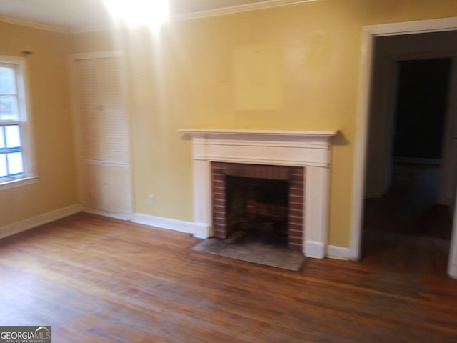 unfurnished living room featuring ornamental molding, a fireplace, and wood-type flooring