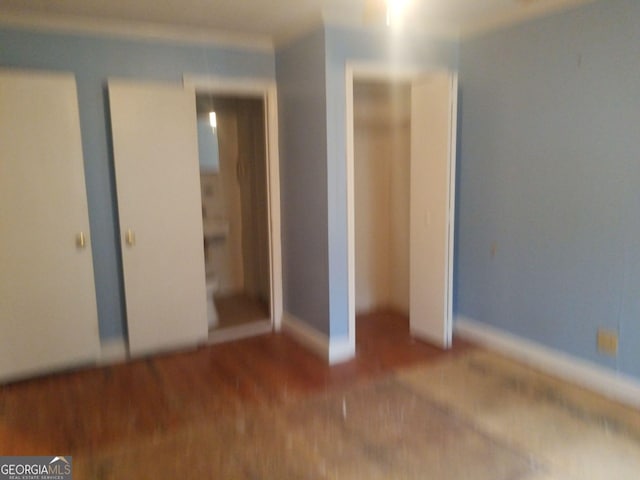 unfurnished bedroom featuring wood-type flooring and a closet