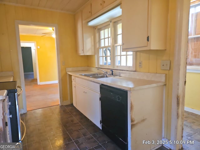 kitchen with stove, sink, white cabinets, and dishwasher