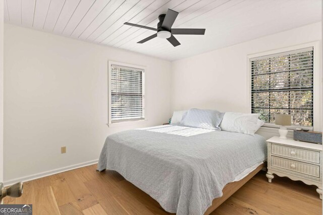 bedroom with wood ceiling, ceiling fan, and light hardwood / wood-style flooring