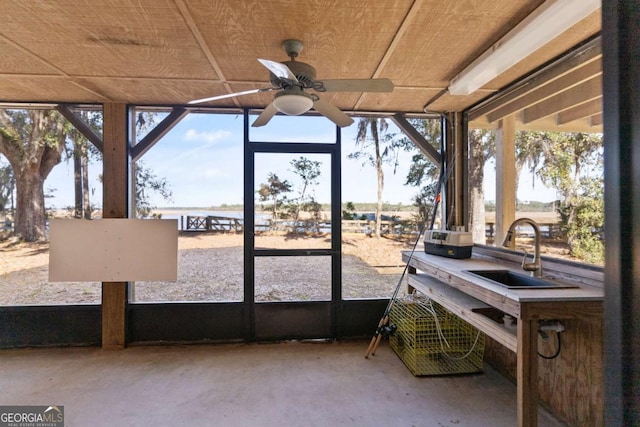 sunroom featuring ceiling fan, a healthy amount of sunlight, and sink