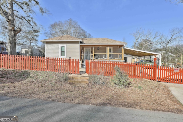 view of front of property with a porch and a carport