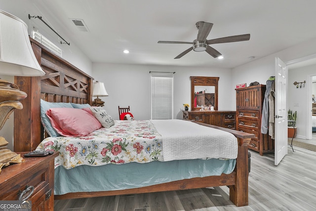 bedroom with ceiling fan and light hardwood / wood-style flooring