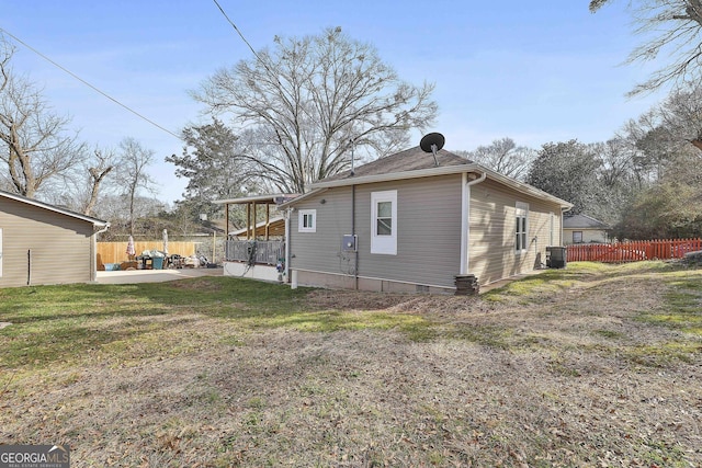 view of home's exterior with a patio, central AC, and a lawn