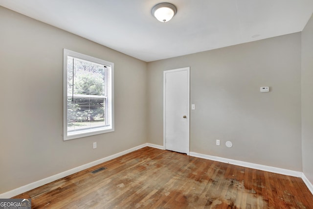 empty room featuring wood-type flooring