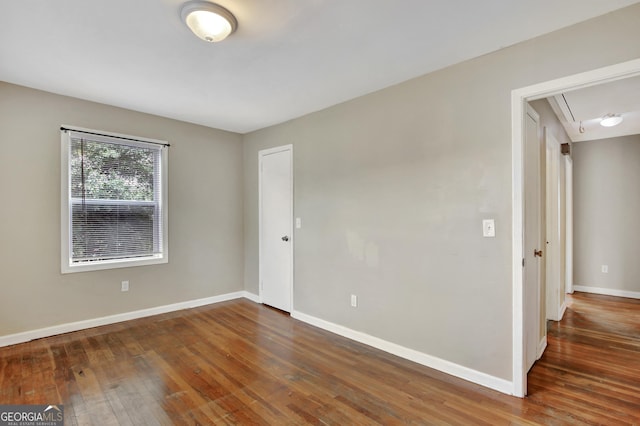 empty room with dark wood-type flooring