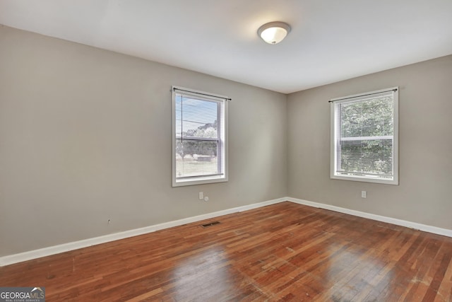 unfurnished room featuring hardwood / wood-style floors