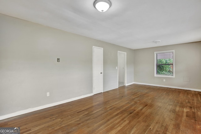 spare room with wood-type flooring