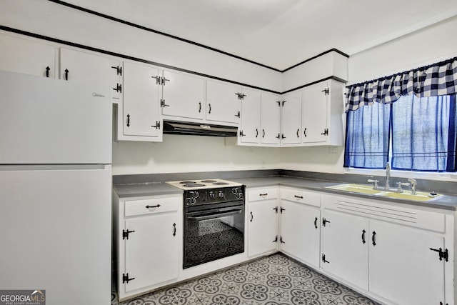 kitchen with sink, white cabinetry, range with electric stovetop, oven, and white fridge