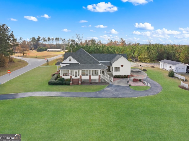 view of front of house with covered porch and a front lawn