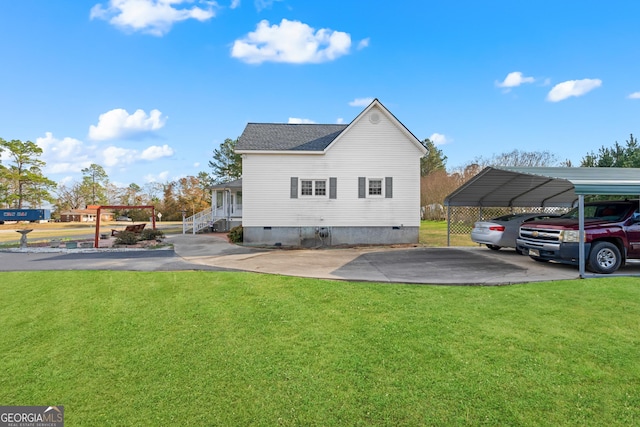 back of house featuring a carport and a yard