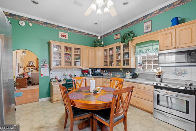 kitchen featuring crown molding, ceiling fan, stainless steel appliances, and light brown cabinetry