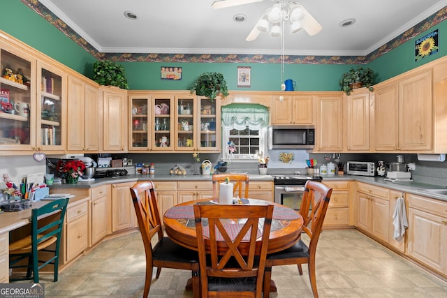 kitchen featuring light brown cabinetry, ornamental molding, ceiling fan, and appliances with stainless steel finishes