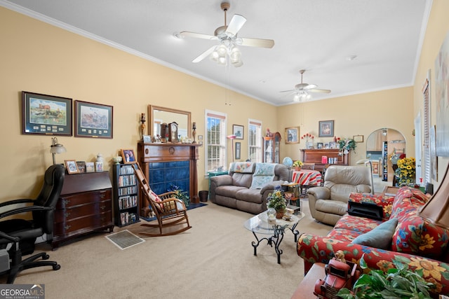 carpeted living room with crown molding and ceiling fan