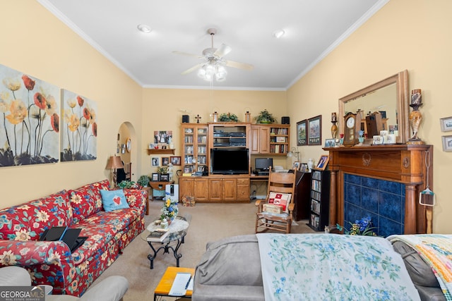 carpeted living room featuring ornamental molding and ceiling fan