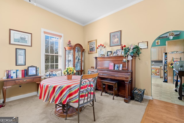 dining space featuring crown molding