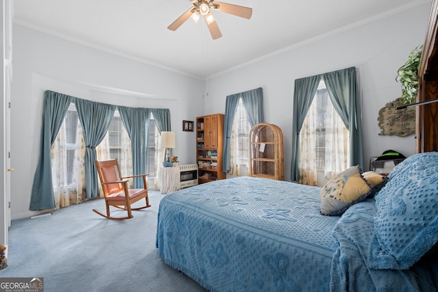 bedroom featuring crown molding, carpet floors, and ceiling fan