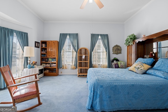 carpeted bedroom with crown molding and ceiling fan