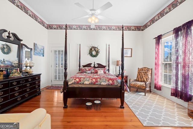 bedroom featuring ceiling fan, wood-type flooring, and access to outside