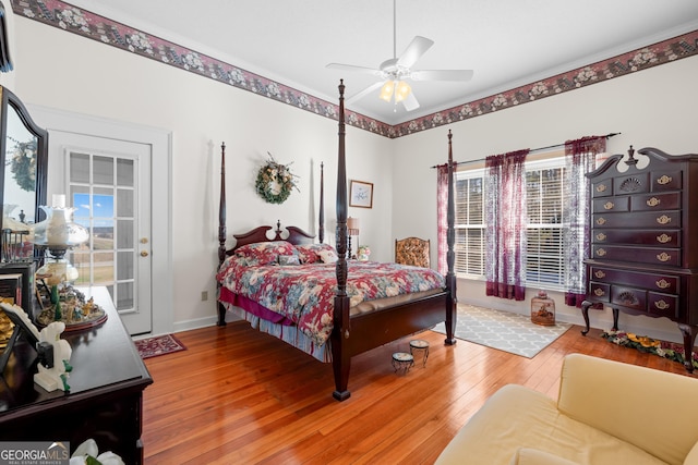 bedroom with access to exterior, wood-type flooring, and ceiling fan