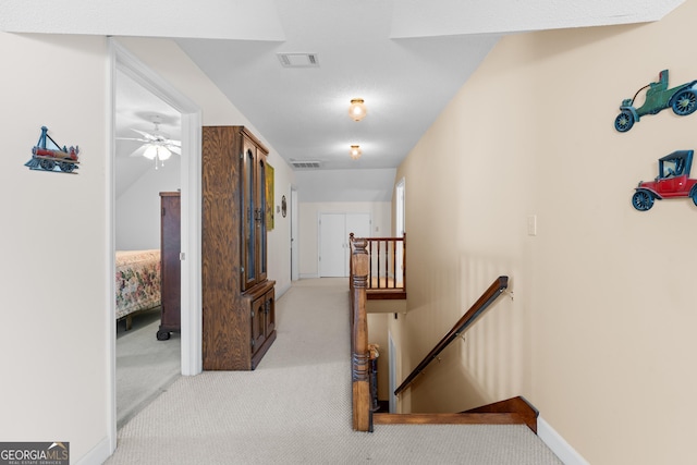 hallway featuring light carpet