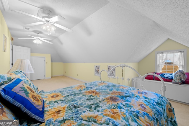 bedroom with vaulted ceiling, ceiling fan, light carpet, and a textured ceiling