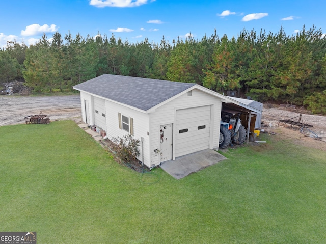 garage featuring a yard and a carport