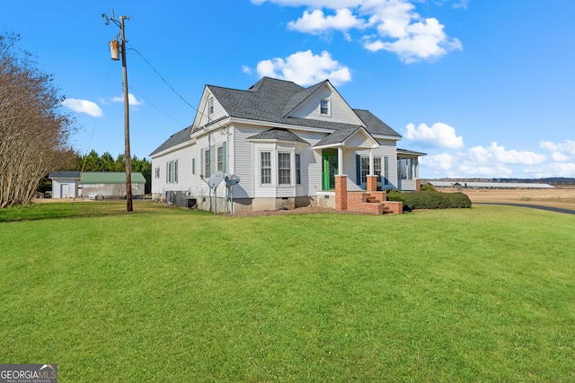 view of front of property with cooling unit and a front lawn