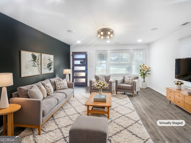 living room with vaulted ceiling and light wood-type flooring