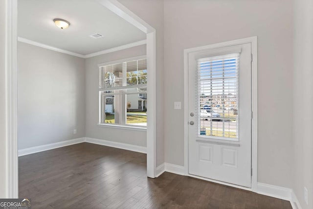 foyer entrance featuring crown molding, a healthy amount of sunlight, and dark hardwood / wood-style floors