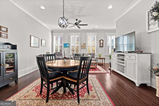 dining room featuring crown molding, dark hardwood / wood-style floors, and ceiling fan with notable chandelier