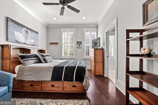 bedroom featuring crown molding, dark wood-type flooring, and ceiling fan