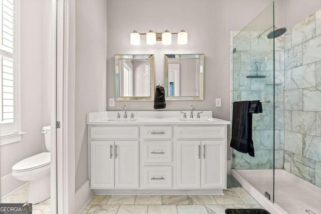 bathroom with vanity, toilet, and a tile shower