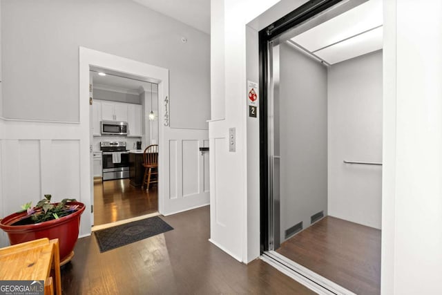 bathroom with elevator and wood-type flooring