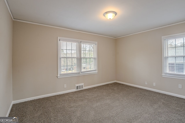 carpeted spare room featuring crown molding