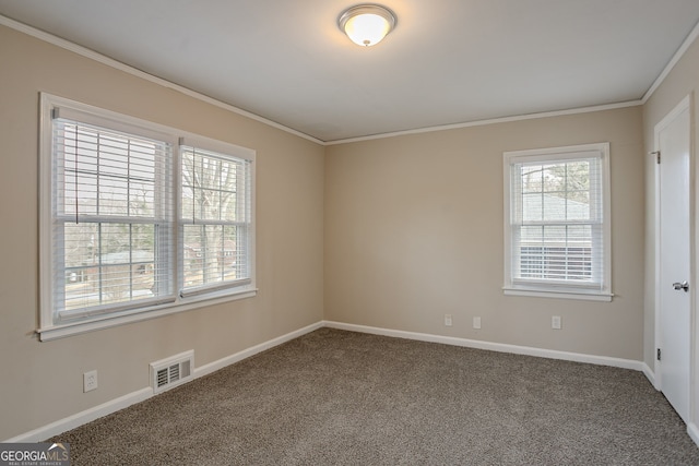 empty room featuring crown molding and carpet flooring