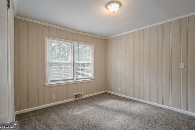 spare room with crown molding and carpet flooring