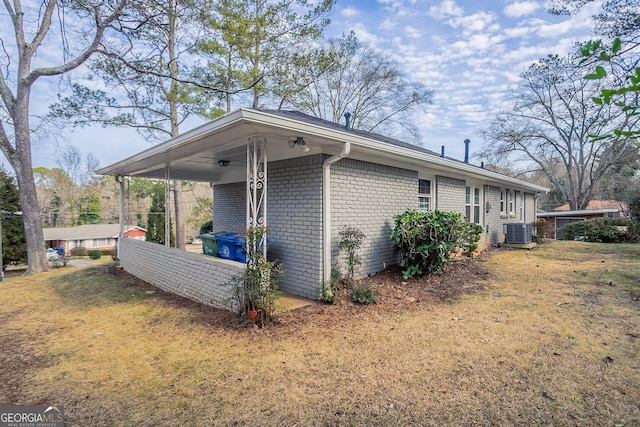 view of home's exterior featuring central AC unit and a lawn