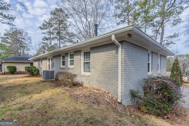 view of property exterior with cooling unit and a lawn