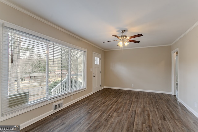 empty room featuring ornamental molding, dark hardwood / wood-style floors, and ceiling fan