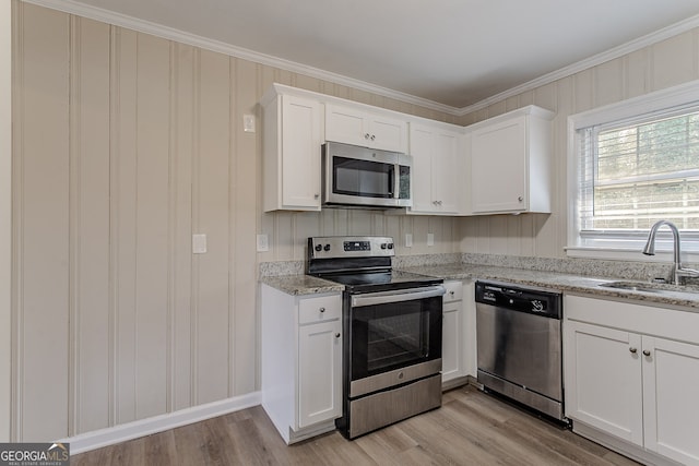 kitchen featuring white cabinetry, stainless steel appliances, sink, and light stone counters