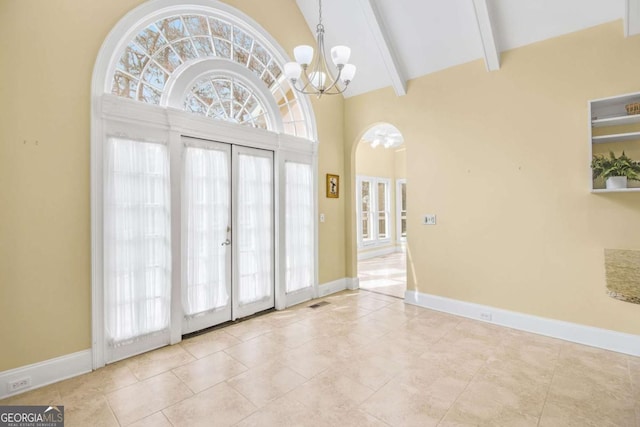 tiled foyer entrance featuring french doors, high vaulted ceiling, an inviting chandelier, and beamed ceiling