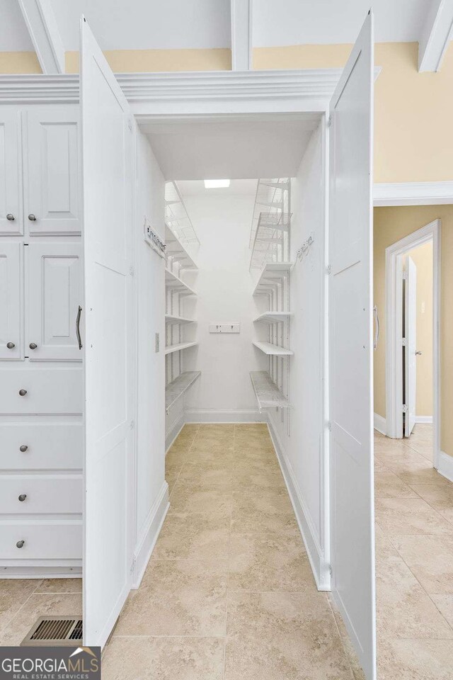 kitchen with sink, stainless steel appliances, light stone countertops, white cabinets, and decorative light fixtures