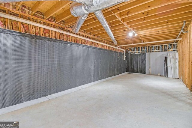 carpeted spare room featuring a paneled ceiling